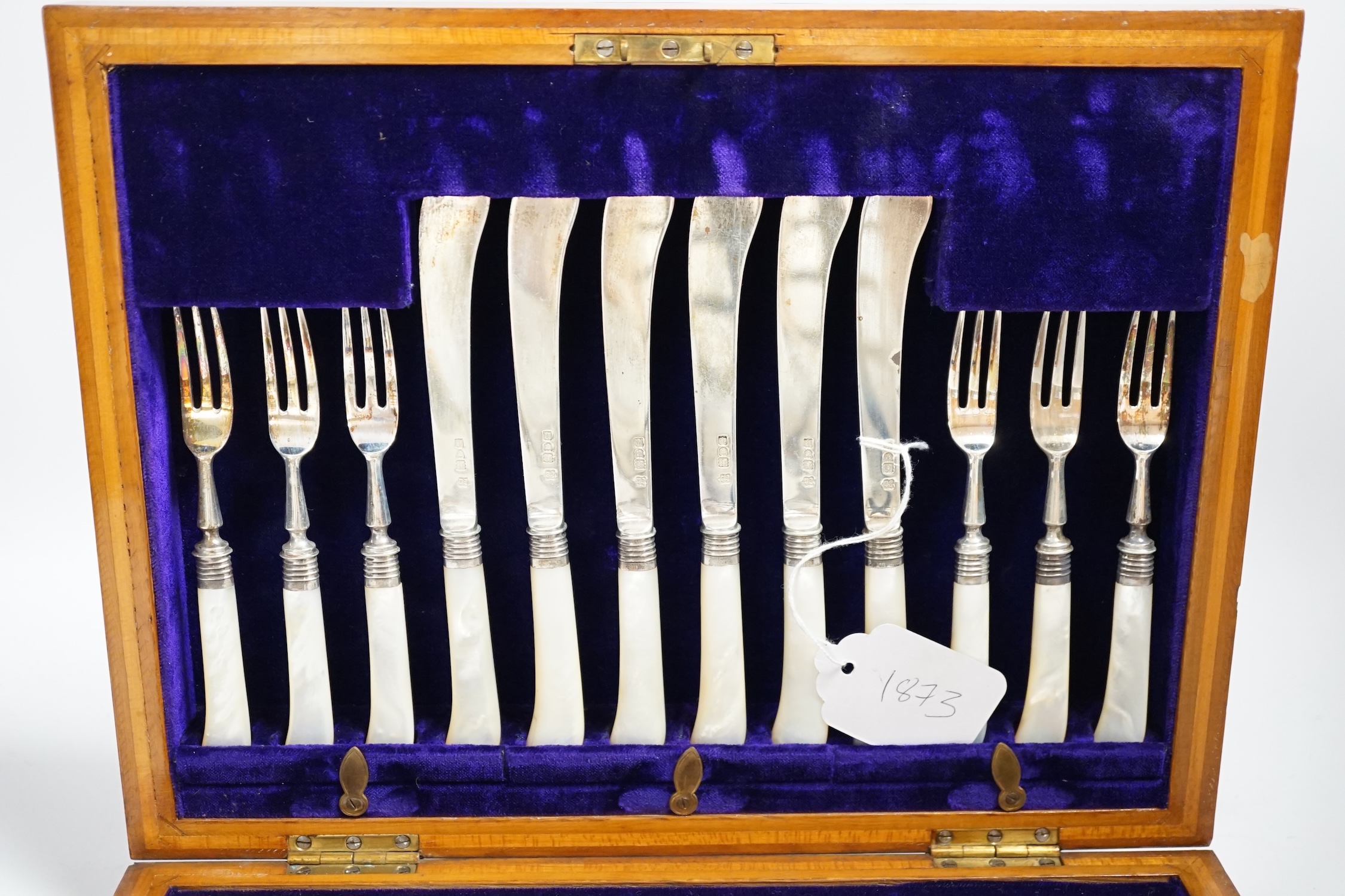 A cased set of twelve pairs of Edwardian silver and mother of pearl pistol handled dessert eaters, Josiah Williams & Co, London, 1908, knife 17.6cm.